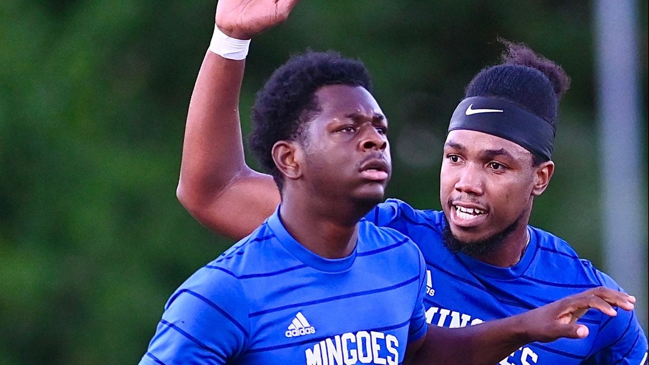 University of The Bahamas Mingoes midfielder Ronaldo Green (Blue #21) celebrates his goal with captain Marlon Barnes (Blue #7) against Western Warriors Titans Wednesday, April 30 at the Roscow Davies Soccer Fields. Mingoes lost 5-1. (UB Athletics).
