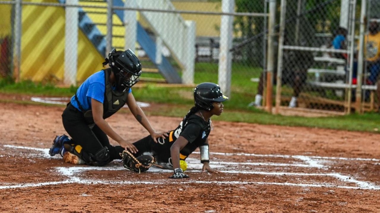 Pitcher Nabria Hamilton safely slides home in the bottom of the first inning to put the Mingoes up 7-2 against the Cyber Tech Blue Marlins on Thursday, July 11. Mingoes won 12-4.