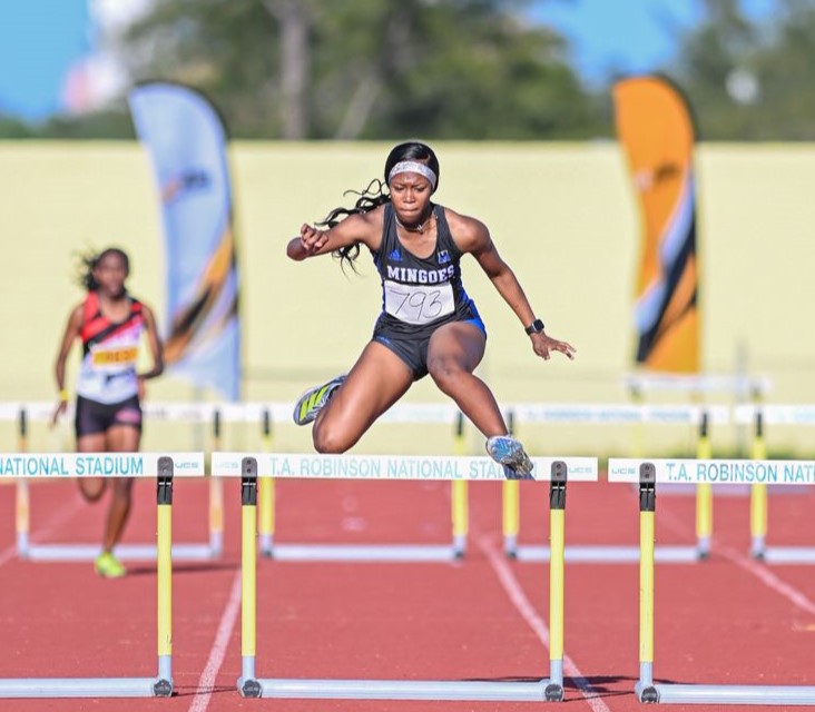 The University of The Bahamas Mingoes sprinter Marquell Newbold gets over the final hurdle in the under-20 women&rsquo;s 400 meters hurdles at the 22nd Star Performers Track and Field meet Saturday, February 1 at the Thomas A. Robinson Track and Field Stadium. (UB ATHLETICS)