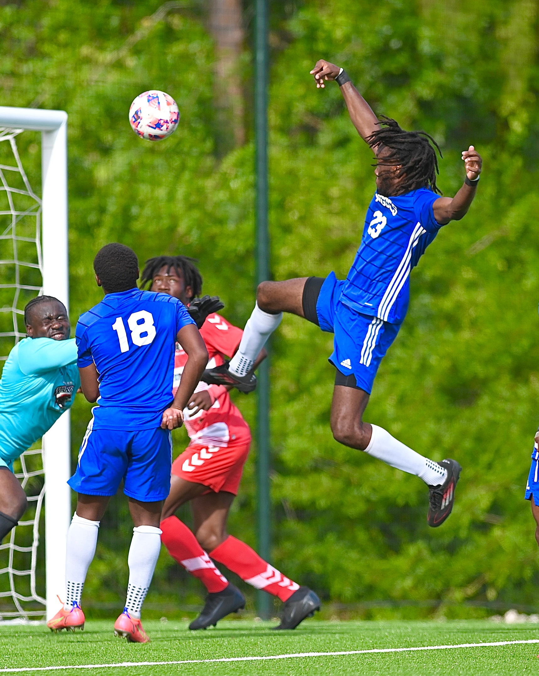 - University of The Bahamas Mingoes midfielder Justin Minns (Blue #23) scores his first goal against Western Warriors Titans Sunday, March 30 at the Roscow Davies Soccer Fields. Mingoes won 5-4. (UB Athletics).